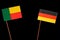 Benin flag with German flag isolated on black