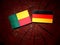 Benin flag with German flag on a tree stump