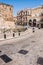 Bent ancient Old Town street Omar Ben el-Hatab near Jaffa gate in Jerusalem, Israel. Walking people, working shops and small