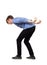 Bent down teenage guy keeps hands back as carrying an heavy invisible object on his shoulders isolated on white background.