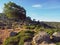 bent green olive tree strange shape and big stones corsician mountains landscape with blue sky background