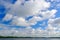 Bentota Ganga river, Sri Lanka. Summer landscape with white stormy clouds. Mangrove trees in the water. Big river in Asia. Beautif