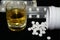 Benzodiazepines or other pills and glass of alcohol, illustrative photo