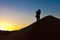 Berber man going up dunes at sunrise in Sahara, Morocco