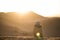 Berber with turban watching the sunset in the dune landscape in the Sahara desert