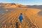 Berber walking with camel at Erg Chebbi, Morocco