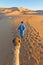 Berber walking with camel at Erg Chebbi, Morocco