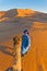 Berber walking with camel at Erg Chebbi, Morocco