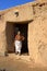 Berber woman standing at door of home