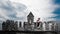 Bergamo Bagpipe. Man rings near traditional religious rural building of pebbles