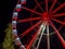 Bergamo, Italy. The Ferris wheel illuminated in red in the evening. Christmas time. Fun attraction