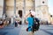 Bergamo Italy girl backpacker standing with backshot photo temple attractions behind a black backpack