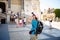 Bergamo Italy girl backpacker standing with backshot photo temple attractions behind a black backpack