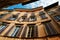 Bergamo, Italy. View of a tall ancient building with large windows.