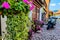 Bergheim / France 19th August 2018:A motor bike parked on the side of a wall with lot of flowers in France