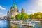 Berlin Cathedral with boat on Spree river at sunset, Germany