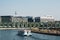 Berlin cityscape with boat on river Spree, people sitting on riv