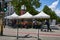 Berlin cityscape with a market stall for fruit and vegetables on the roadside with customers and passers-by