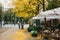 Berlin, December 12, 2017: The autumn city scene. Street in Berlin. The yellow foliage lies on the sidewalk. The family