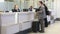 BERLIN, GERMANY - 28 JANUARY 2015: Man getting information at airport information desk at Tegel airport in Berlin.