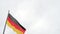 BERLIN, GERMANY - MAY 24, 2017: German flags fluttering in moody day on sky background