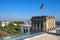 Berlin, Germany - Rooftop of the Reichstag building with the historic corner tower and Germany flag with Berlin skyline in