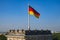 Berlin, Germany - Rooftop of the Reichstag building with the historic corner tower and Germany flag with Berlin skyline in