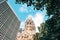 Berlin Kaiser Wilhelm Memorial Church tower surrounded by tree.