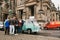 Berlin, October 1, 2017: Group of young unknown tourists book tourist trip on blue retro mini bus next to the Berlin