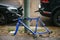 Berlin, October 2, 2017: Blue bicycle attached to street pillar with lock stands without wheels after being stolen in