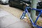 Berlin, October 2, 2017: Blue bicycle attached to street pillar with lock stands without wheels after being stolen in