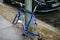 Berlin, October 2, 2017: Blue bicycle attached to street pillar with lock stands without wheels after being stolen in