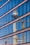 Berlin TV-tower and cranes reflecting in a glass facade