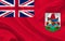 Bermuda country flag on wavy silk fabric background panorama