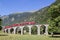 Bernina Express train is going through the famous circular viaduct