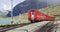 Bernina pass, Switzerland. The famous red train is leaving the Ospizio Bernina station to Saint Moritz. Best of Swiss