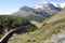 The Bernina train drives over the Swiss Alps in the Oberengadin from Pontresina via Bernina-Hospitz to Alp GrÃ¼m and ends in