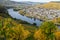 Bernkastel-Kues and the river Moselle in autumn with multi colored vineyard in the foreground