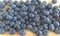 The berries of blueberry scattered on a cutting board