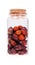 Berries dried rosehips in a glass bottle with cork stopper, isol