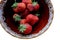 Berries of homegrown strawberries in a ceramic bowl. Isolated. White background