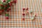 Berries of Hypericum on the gingham check pattern tablecloth