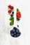 Berries with spoon on Wooden Background.
