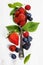 Berries with spoon on Wooden Background.