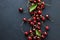 Berry backgrounds with fresh ripe sweet cherries on dark blue stone.