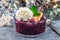 Berry cobbler in glass ramekin with ice cream, Christmas decoration with bokeh, horizontal