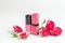 Berry color decorative cosmetics with roses white background close up