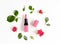 Berry color decorative cosmetics with roses white background top view