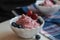 berry cottage cheese cream in white sauce bowls, the dish is decorated with fresh berries