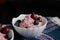 berry cottage cheese cream in white sauce bowls, the dish is decorated with fresh berries